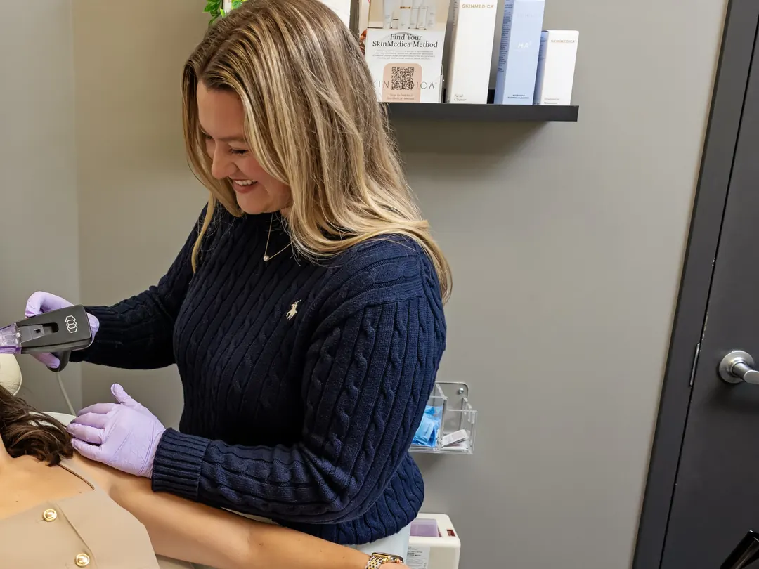 A provider performing Morpheus8 in a treatment room lined with skin care products